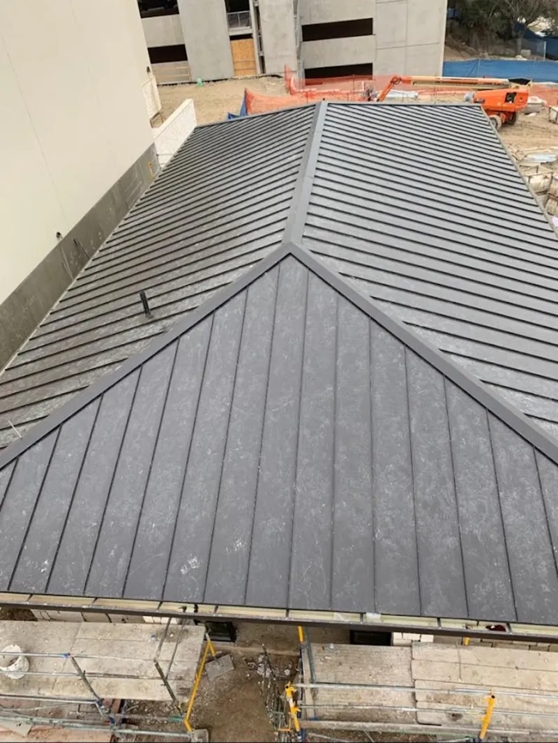 Commercial metal roof construction with crane equipment in Skokie