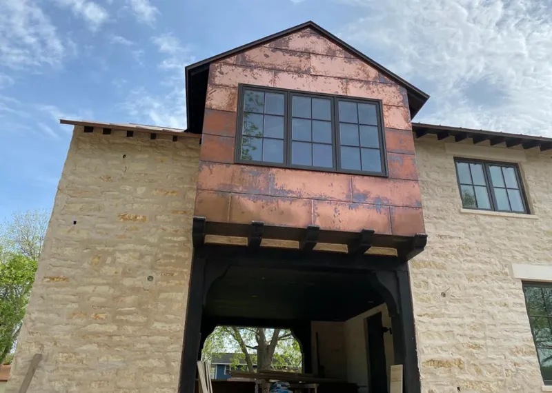 Copper metal panel facade on a stone building for Skylight Installation in Skokie