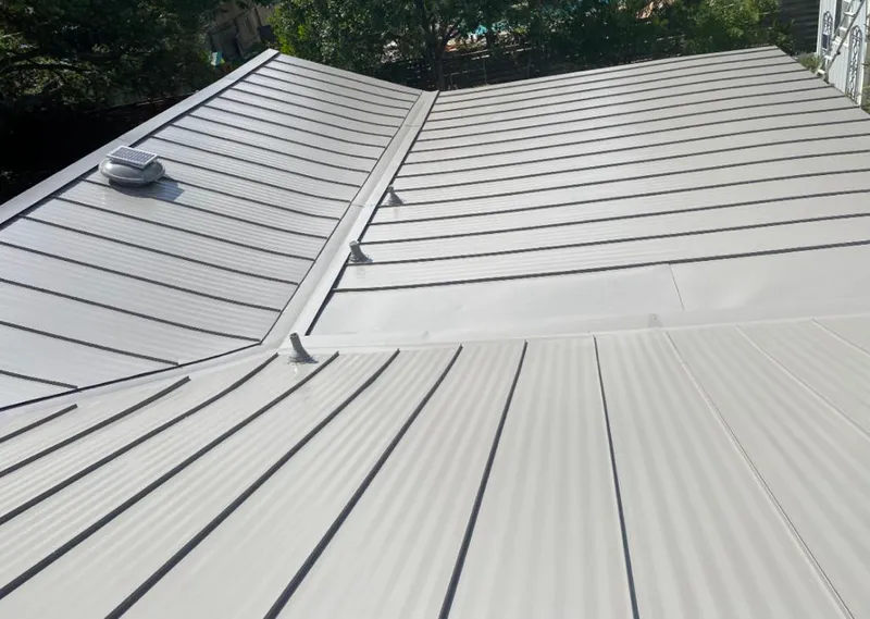 Solar attic fan installed on a metal roof for Roof Ventilation in Skokie